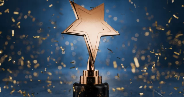 Gold star trophy with confetti falling