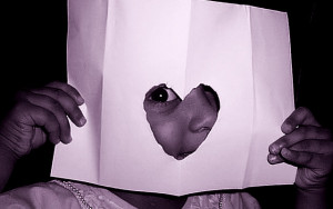 Little Girl Peeking Thru Heart-Shaped Hole.flickrCC.abcdz2000