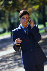 Barcelona, Spain --- Businesswoman Using Cellular Phone Outdoors --- Image by © Leslie Richard Jacobs/Corbis