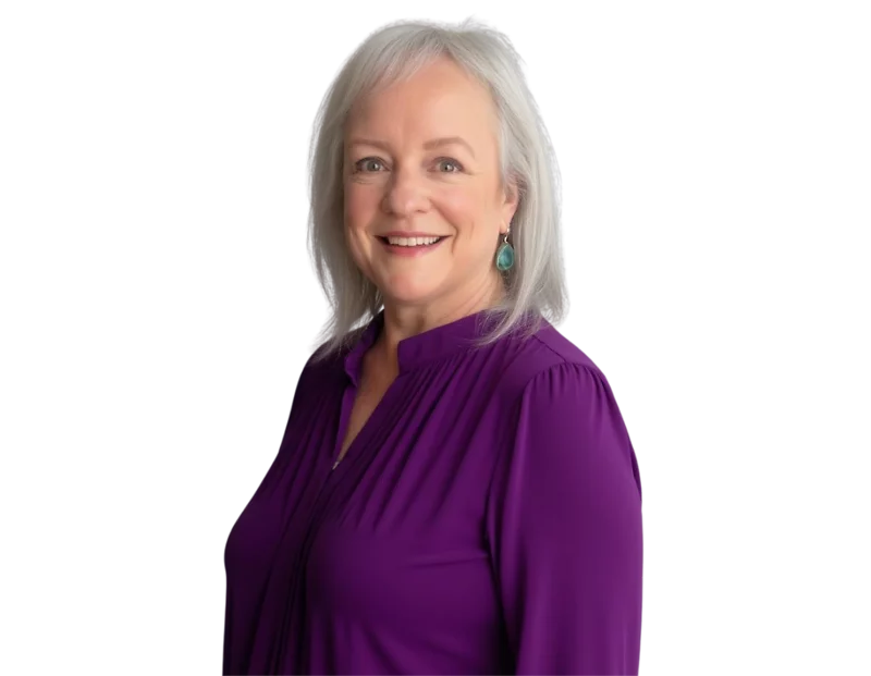 Sarah Robertson has straight shoulder-length gray hair wearing a bright purple blouse and turquoise drop earrings, posed against a transparent background. Her warm expression and colorful outfit create a friendly and approachable professional portrait.