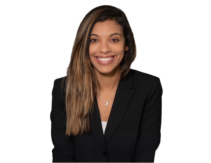 Professional headshot of Joyce Dos Santos wearing a black blazer and crescent moon necklace, posed against a transparent background. She appears confident and approachable, suggesting a professional or business context.