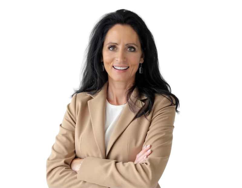 Professional headshot of Teresa Bult, a woman with long dark hair wearing a tan blazer over a white top, smiling confidently with arms crossed. The background is removed for a clean, transparent look.