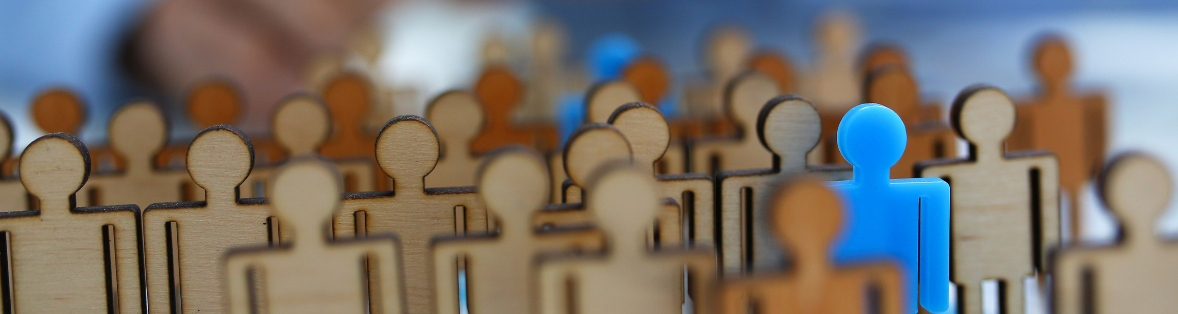 Group of wooden people outlines standing