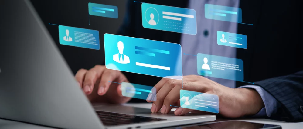 person working on a laptop with digital profile icons