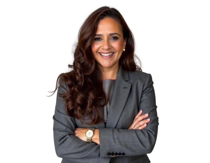 Anjie Cabrera in a gray suit and blouse, smiling in front of a light geometric background.