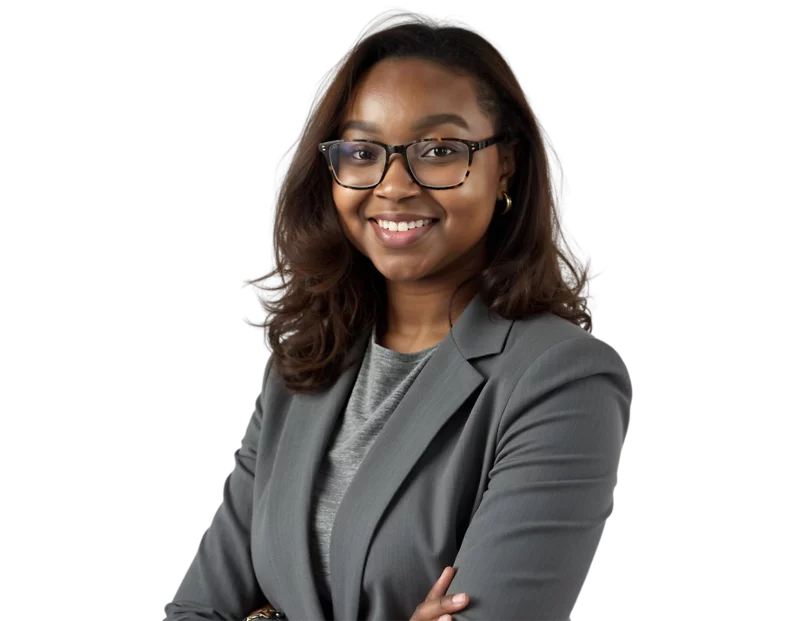 A confident woman wearing glasses and a gray business suit smiles with her arms crossed against a transparent background. Her professional attire and posture suggest a business or leadership context.