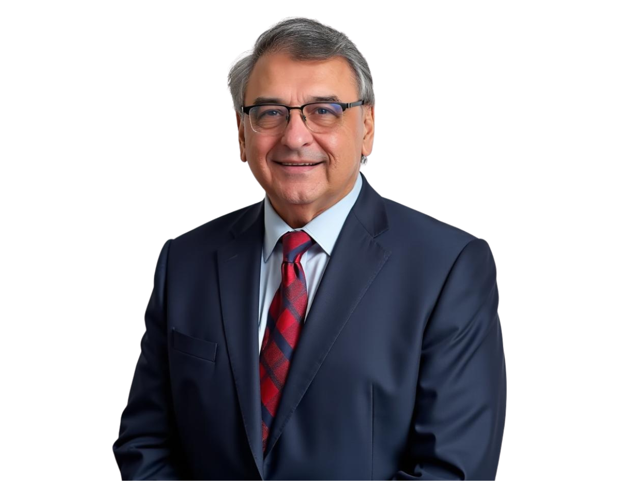 Older man in a navy blue suit and red patterned tie, smiling warmly while wearing glasses, posed against a transparent background. His formal attire and professional demeanor suggest a corporate or leadership role.