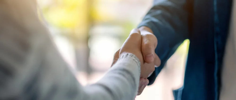 Closeup image of two people shaking hands