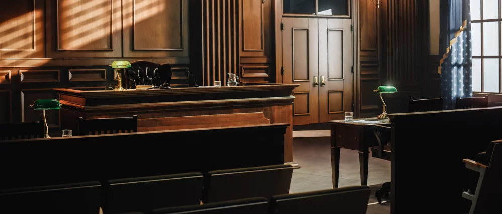 Empty American Style Courtroom. Supreme Court of Law and Justice Trial Stand. Courthouse Before Civil Case Hearing Starts. Grand Wooden Interior with Judge's Bench, Defendant's and Plaintiff's Tables.