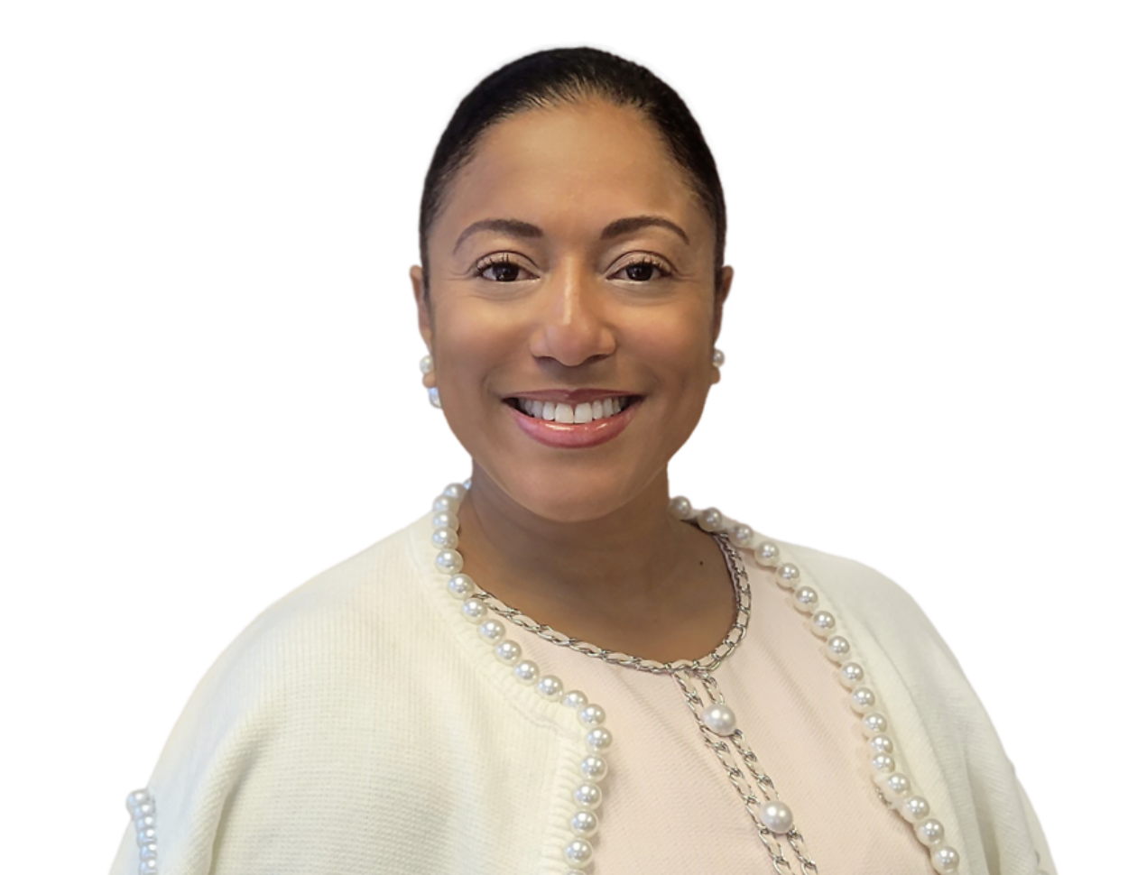 Tiffany Harlow, smiling with pulled-back dark hair wearing pearl earrings, a light pink top, and a white cardigan adorned with pearl trim.