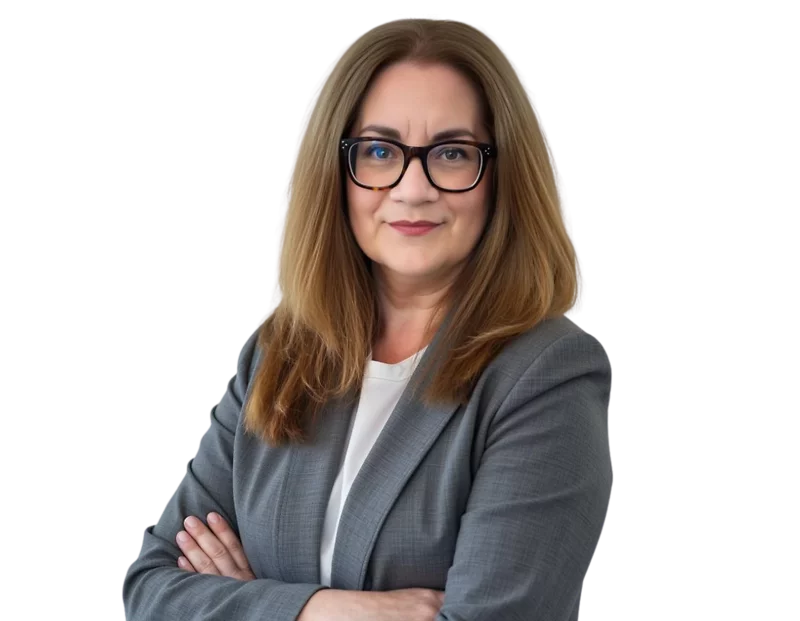 Regina Musolino poses in a gray blazer over a white top. She stands against a transparent background with a composed, professional expression, conveying experience and confidence.