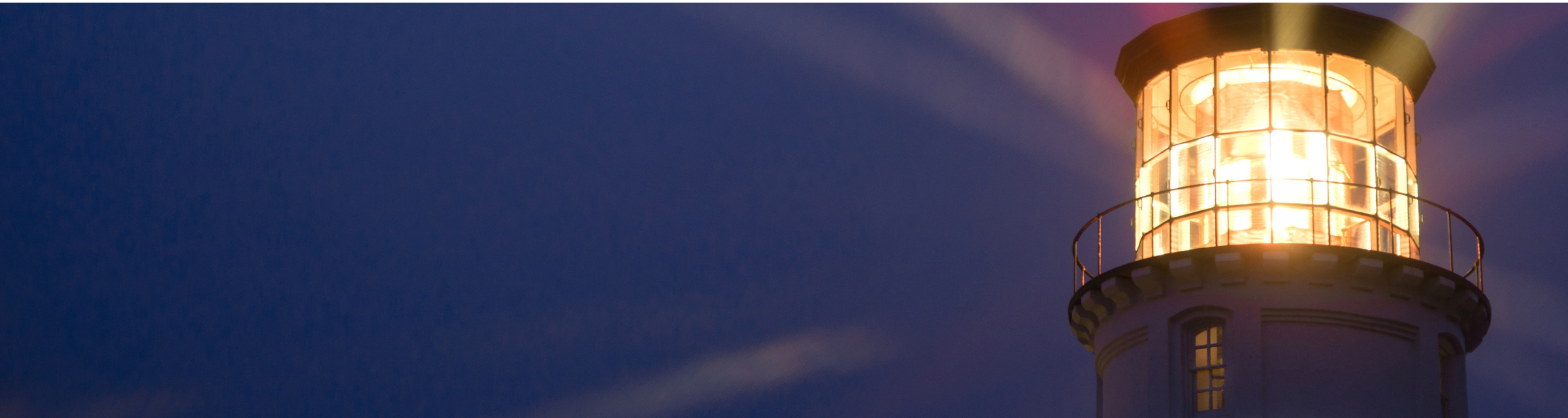 Banner photo of Advice & Counsel practice, depicting a Lighthouse Beams Illumination Into Rain Storm Maritime Nautical stock photo