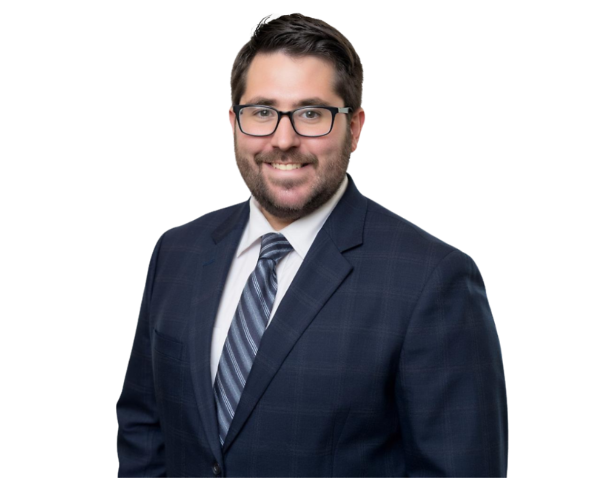 Smiling man with dark hair, beard, and glasses wearing a dark plaid suit, white shirt, and striped tie. He is standing against a transparent background.