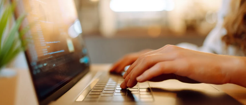 Female hands working on a laptop, close-up. Technology, Freelance, online course, remote work and lifestyle concept.