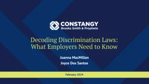 Constangy Brooks Smith & Prophete webinar slide titled 'Decoding Discrimination Laws: What Employers Need to Know' by Joanna MacMillan and Joyce Dos Santos, dated February 2024. The background is a dark blue geometric pattern with green accents.