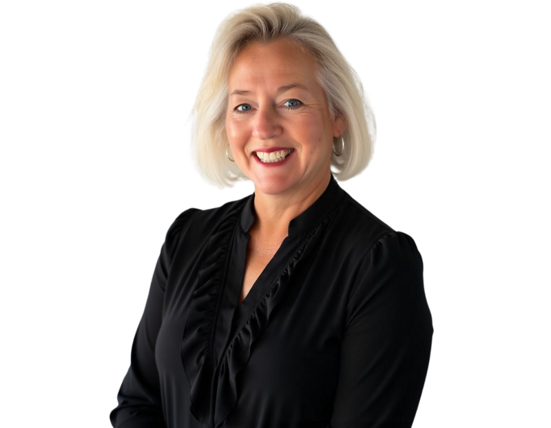 Jeanette Phelan wearing a black blouse with ruffled detailing, posed against a light blue and white geometric background.