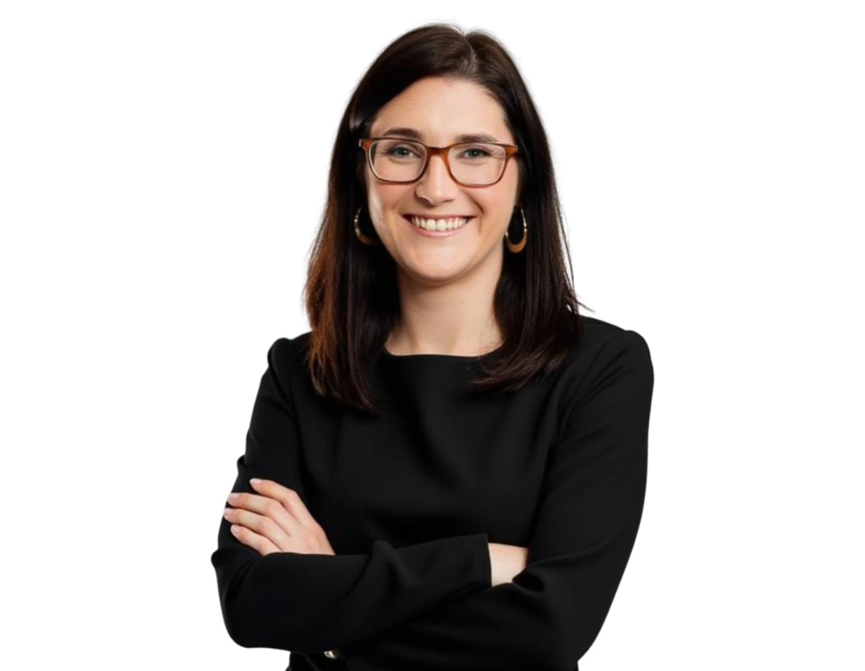 Woman with straight dark brown hair wearing glasses, gold hoop earrings, and a black long-sleeve dress, smiling with arms crossed against a transparent background.