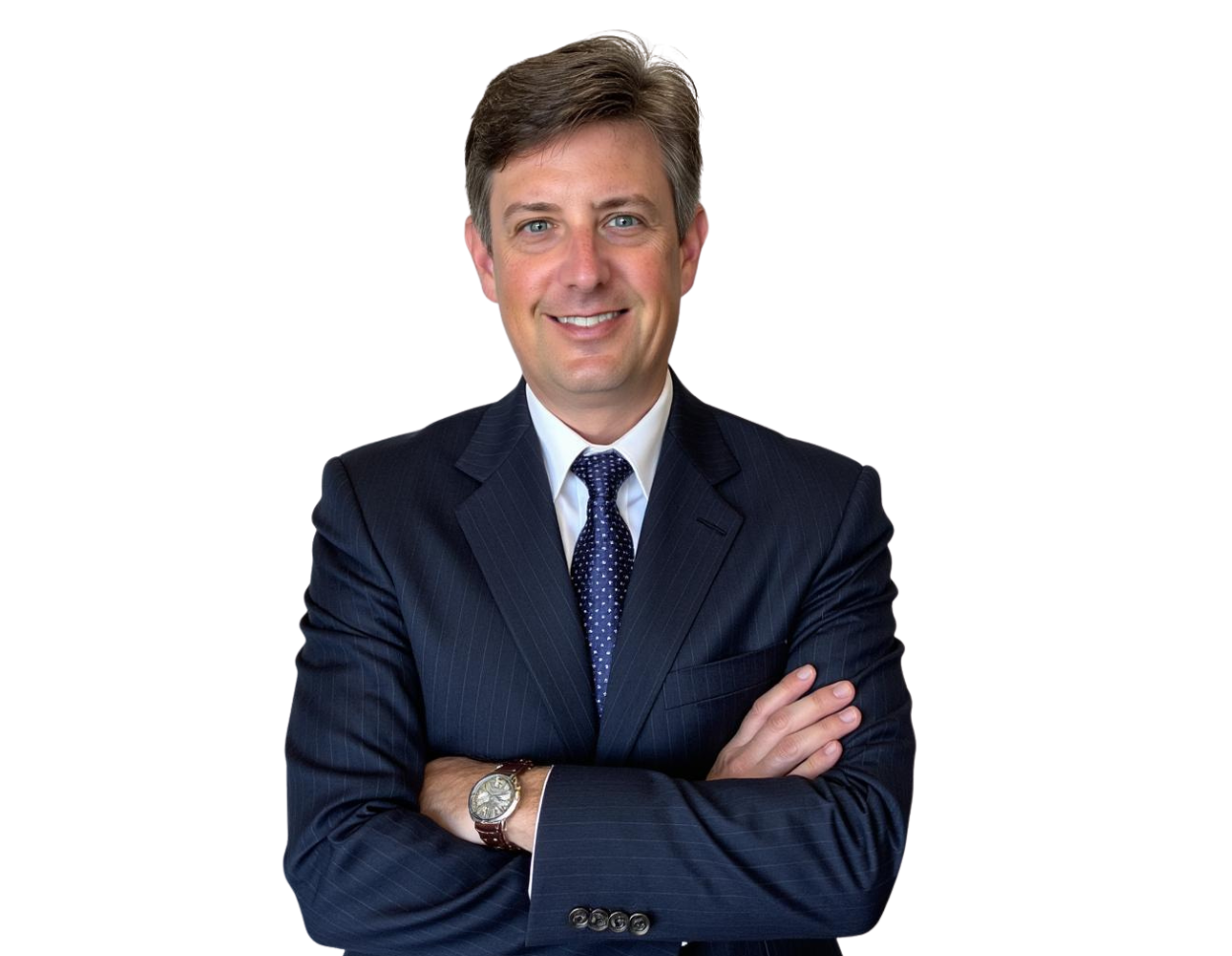 Jason Logan in a dark pinstripe suit with a white shirt and navy patterned tie stands with arms crossed, smiling against a light blue and white geometric background.