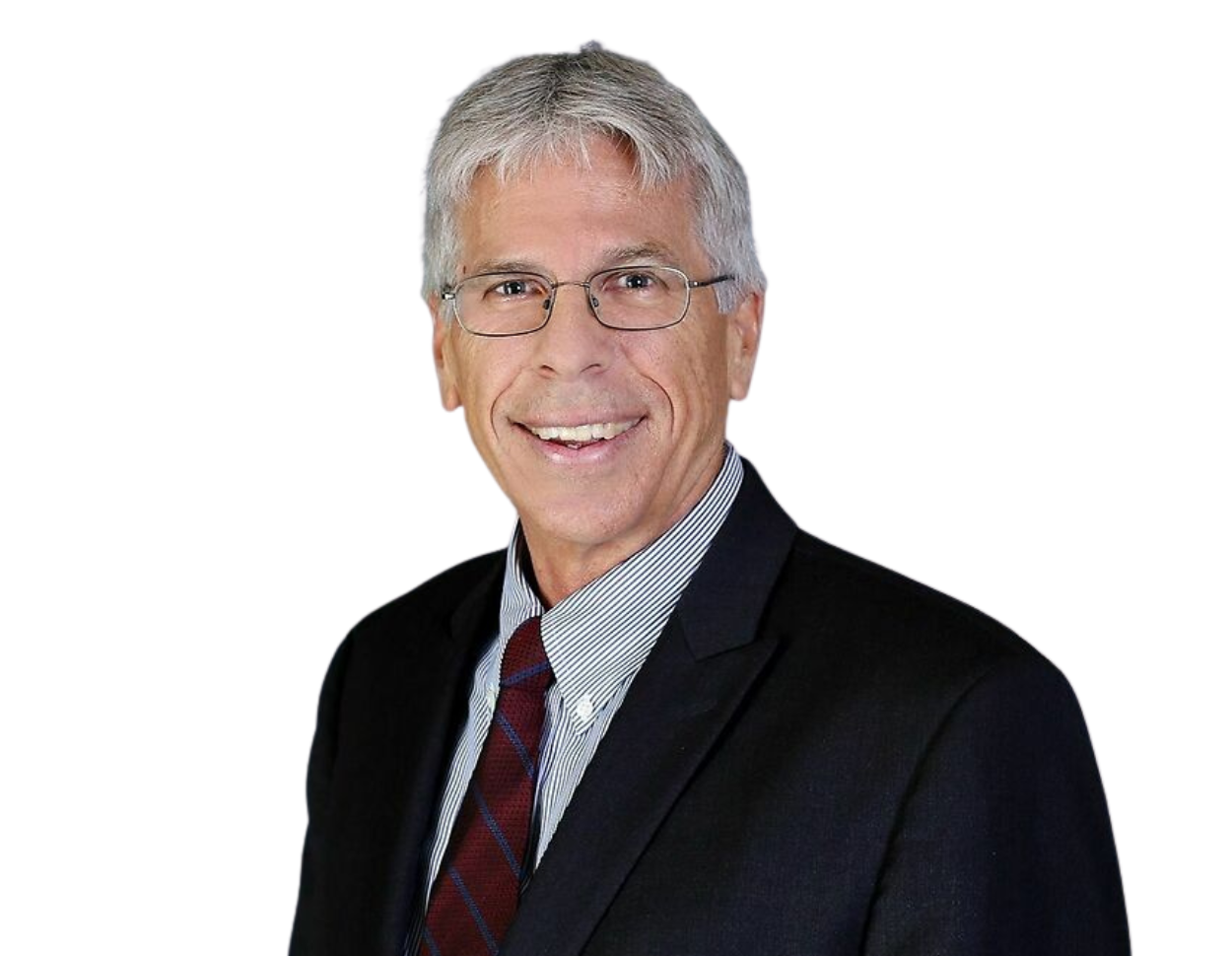 Glenn Bunting, smiling glasses wearing a dark suit, white striped shirt, and a red-and-blue striped tie against a plain background.