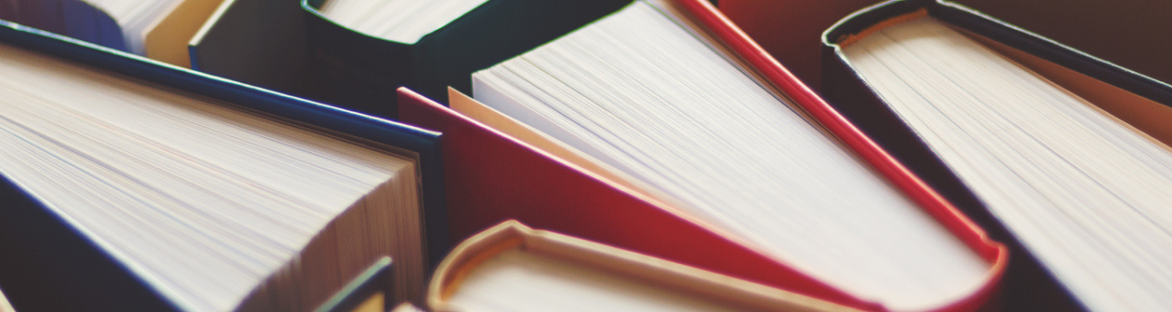 Many hardbound books background, selective focus
