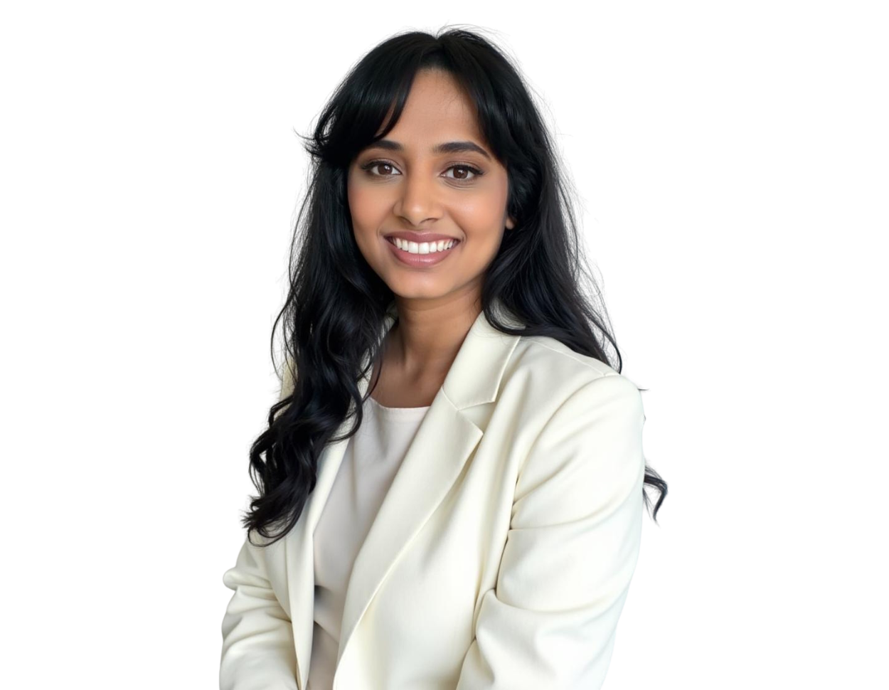 Deepa Kollipara smiling while seated, wearing a cream blazer and blouse, with long wavy black hair against a transparent background.