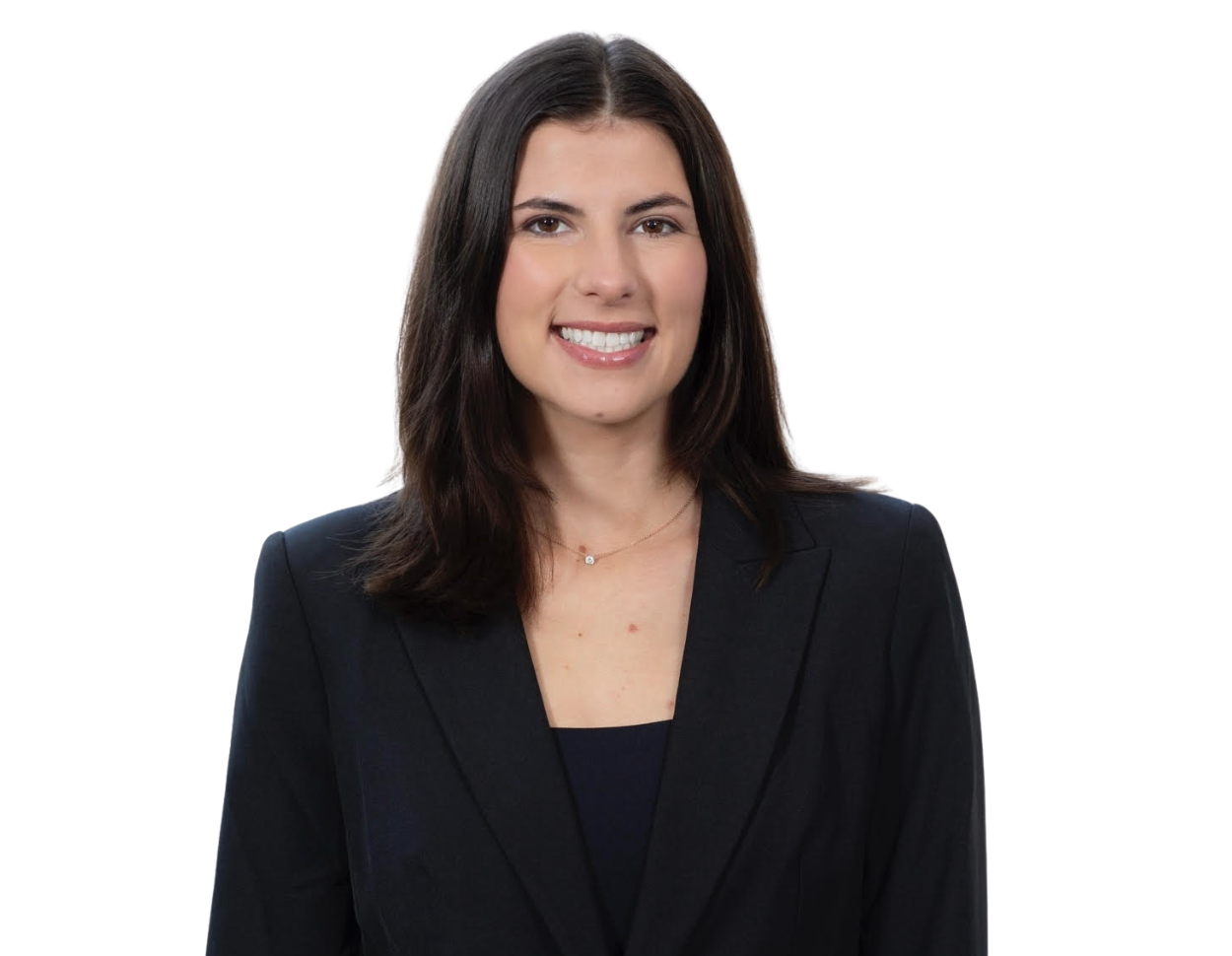 Headshot of a woman with shoulder-length dark brown hair, wearing a black blazer over a dark top. She is smiling and facing forward, with a plain background that emphasizes a professional and polished appearance.