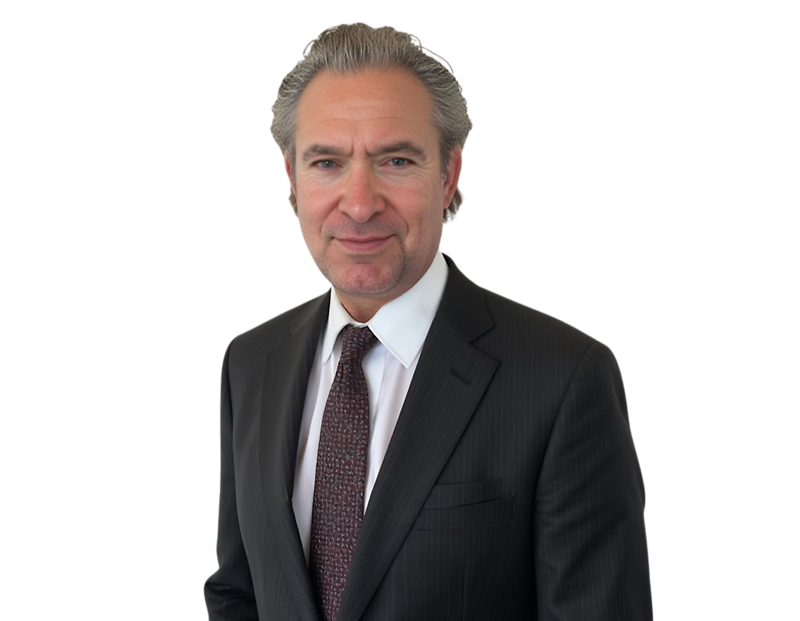 Professional man with gray slicked-back hair wearing a dark pinstripe suit, white dress shirt, and patterned burgundy tie, standing against a transparent background. He has a slight smile and a composed expression, presenting a polished executive appearan