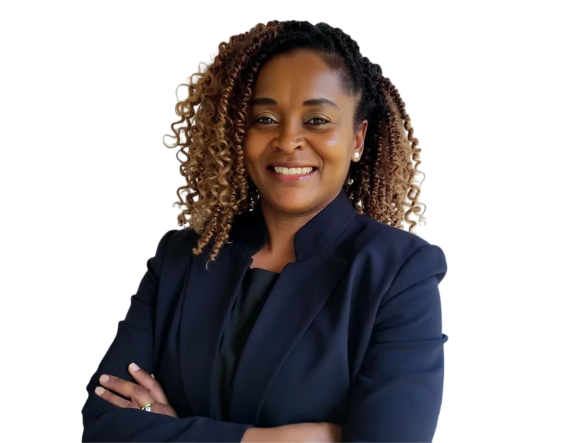 Professional headshot of Barbara Kihumba, senior counsel specializing in immigration law, smiling confidently with arms crossed. She wears a dark blazer over a black top, with curly highlighted hair styled to the side
