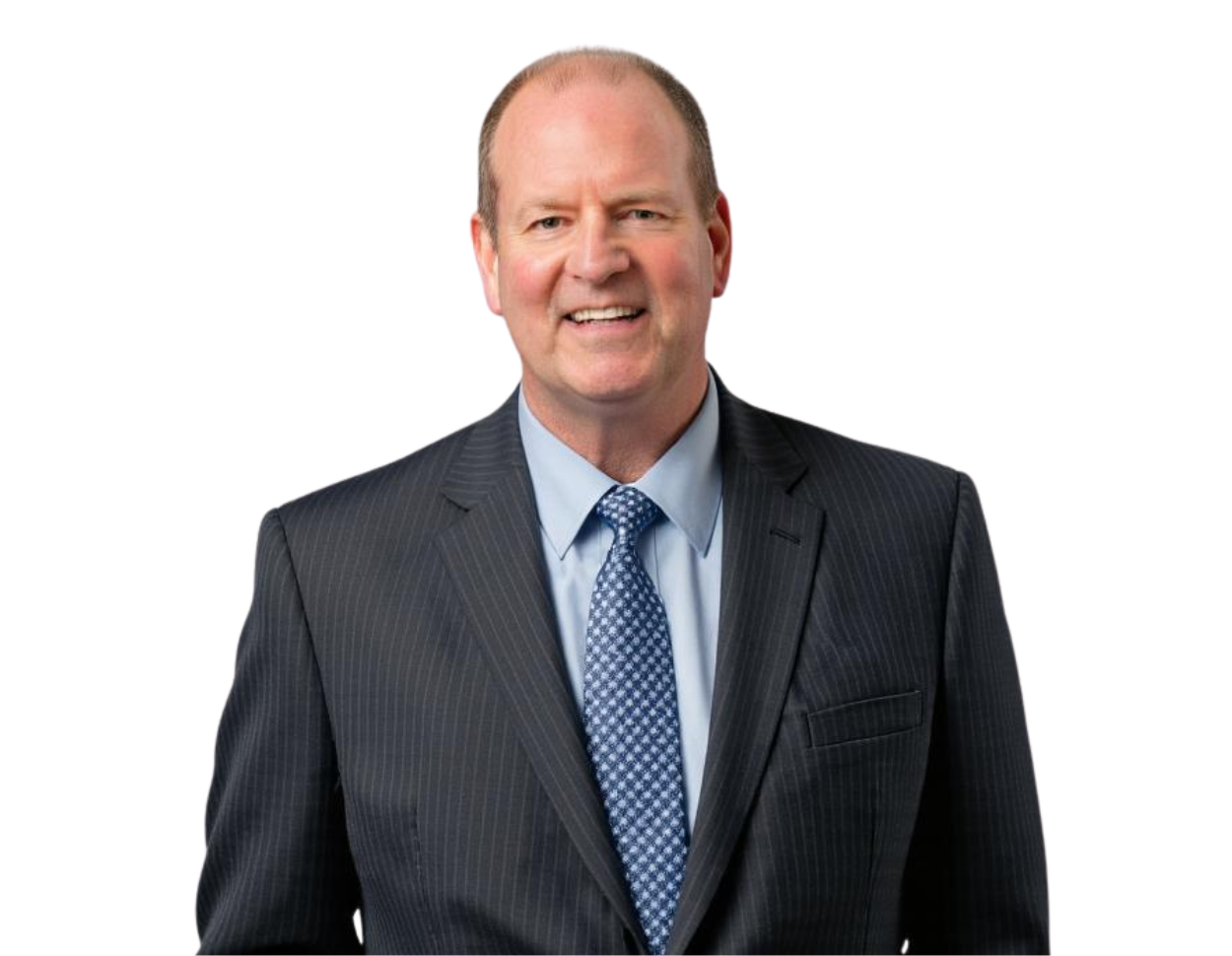 Sean Hoar in a dark pinstriped suit, light blue shirt, and patterned tie, smiling confidently against a transparent background. His posture and attire suggest a professional or corporate setting.