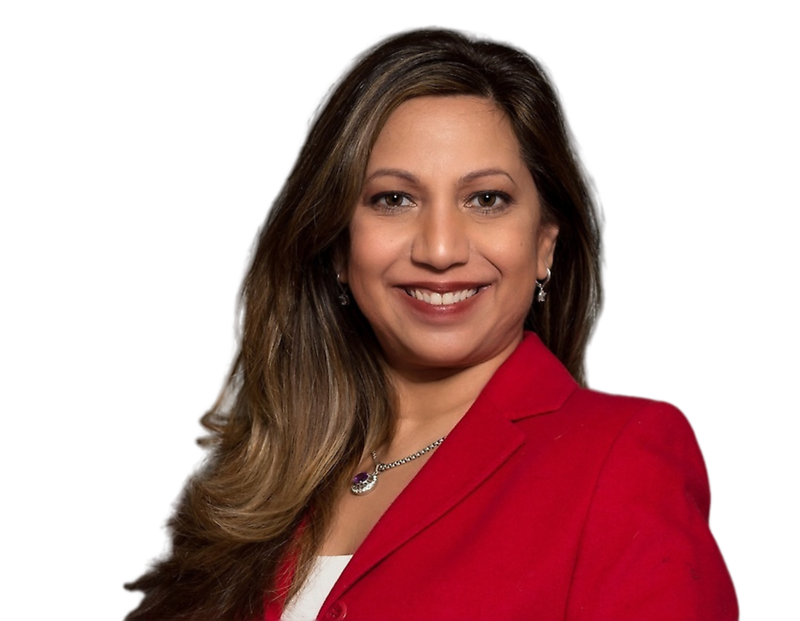 Punam Rogers, smiling, wearing a red blazer over a white top, accessorized with a necklace and earrings, against a plain background.