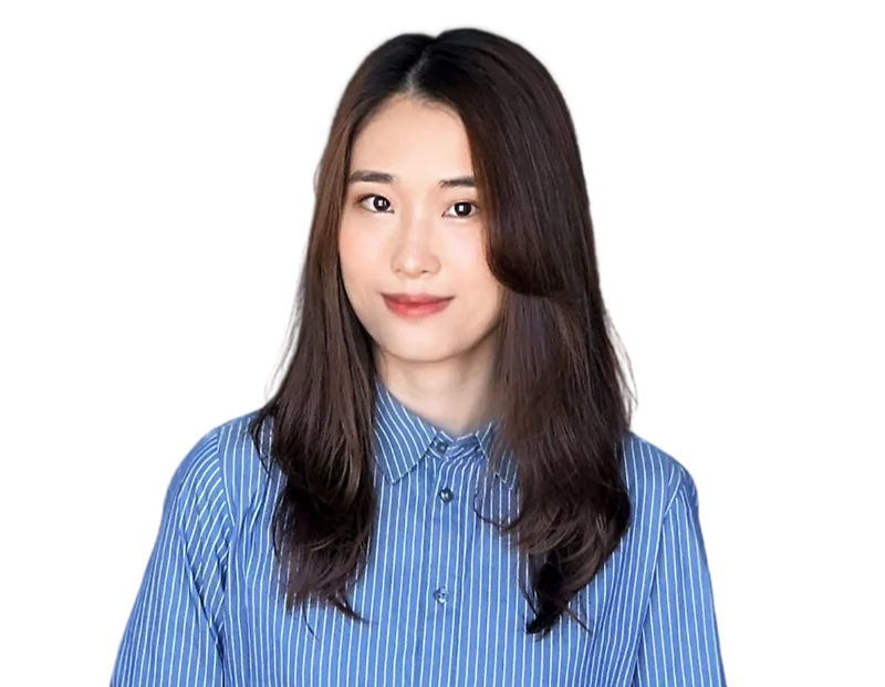 Young woman with long, softly curled dark brown hair wearing a blue and white vertical striped button-up shirt, standing against a transparent background. Her subtle smile and casual-professional outfit give a friendly yet polished impression.