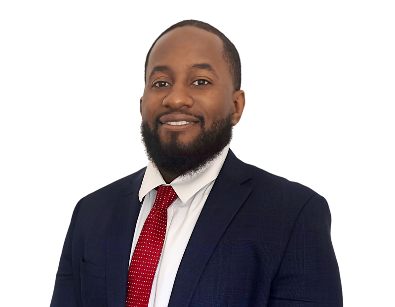 Smiling man with a short beard wearing a dark navy suit, white dress shirt, and red tie with small white dots, posing against a transparent background. He presents a polished and approachable business professional look.