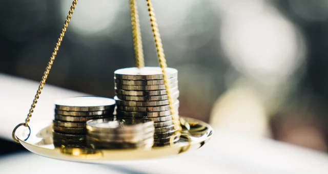 Coins stack with balance scale. Money management, financial plan, time value of money, business idea and Creative ideas for saving money concept.