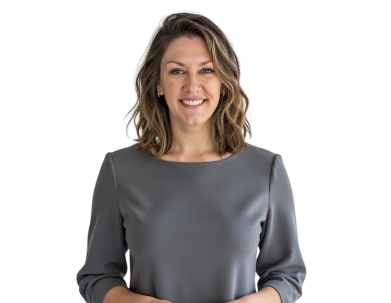 Professional headshot of Aubrey Weaver smiling in front of a light gradient background, wearing a gray blouse with three-quarter sleeves and soft waves in her shoulder-length hair.