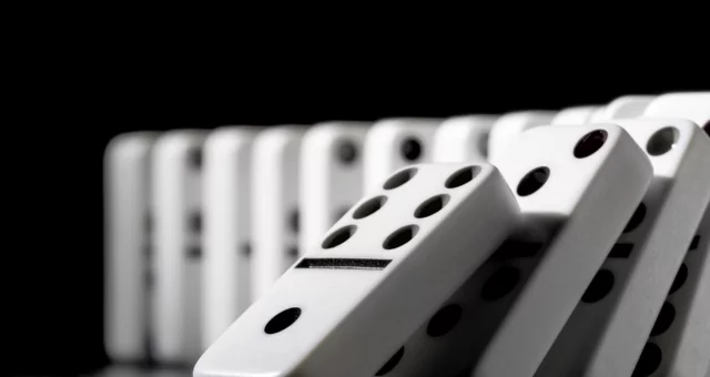 Domino pieces put in a row on black background