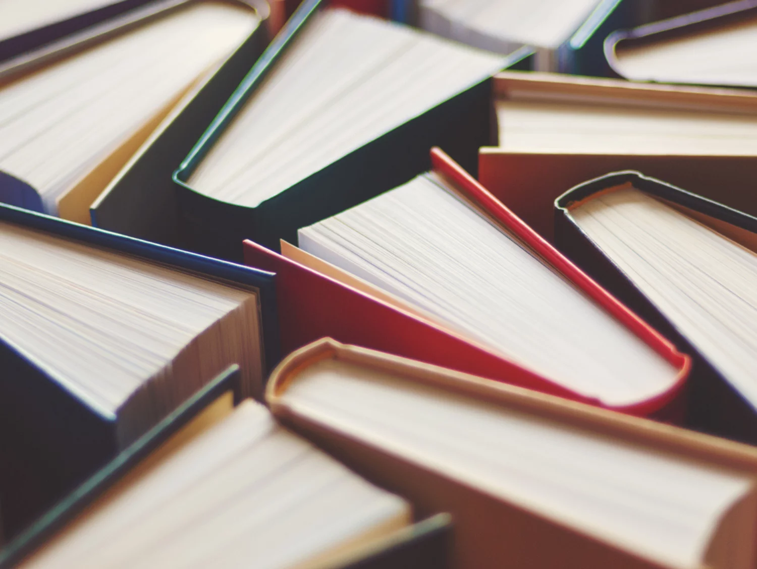 Many hardbound books background, selective focus