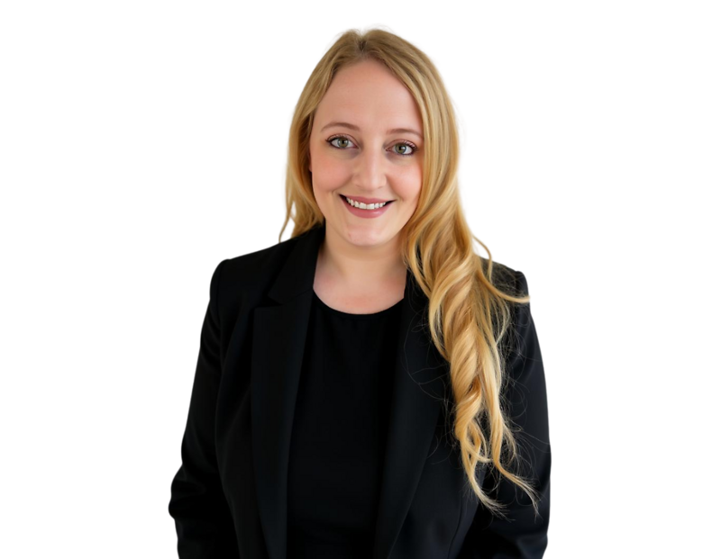 Professional headshot of a smiling woman with long blonde hair, wearing a black blazer and black top, against a plain background.