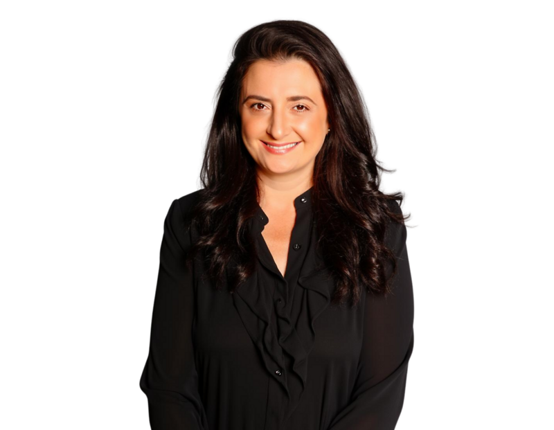 Professional headshot of partner Barbara Antonucci smiling, wearing a black blouse with ruffle detailing and long wavy dark hair, posed against a transparent background.