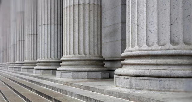 Stone colonnade and stairs detail. Classical pillars row in a building facade