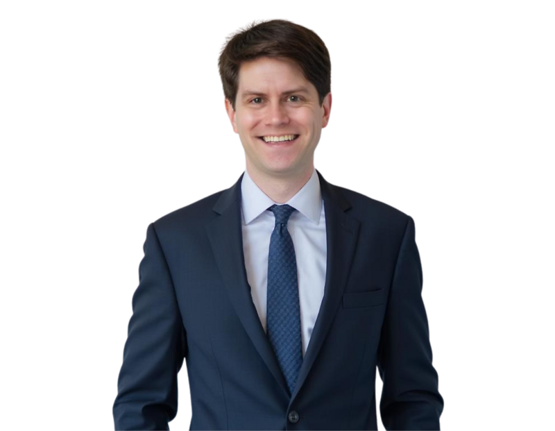 Matthew Clark, a labor and employment attorney, smiling in a navy blue suit with a patterned tie against a plain background. His professional appearance conveys approachability and expertise in workplace legal matters.