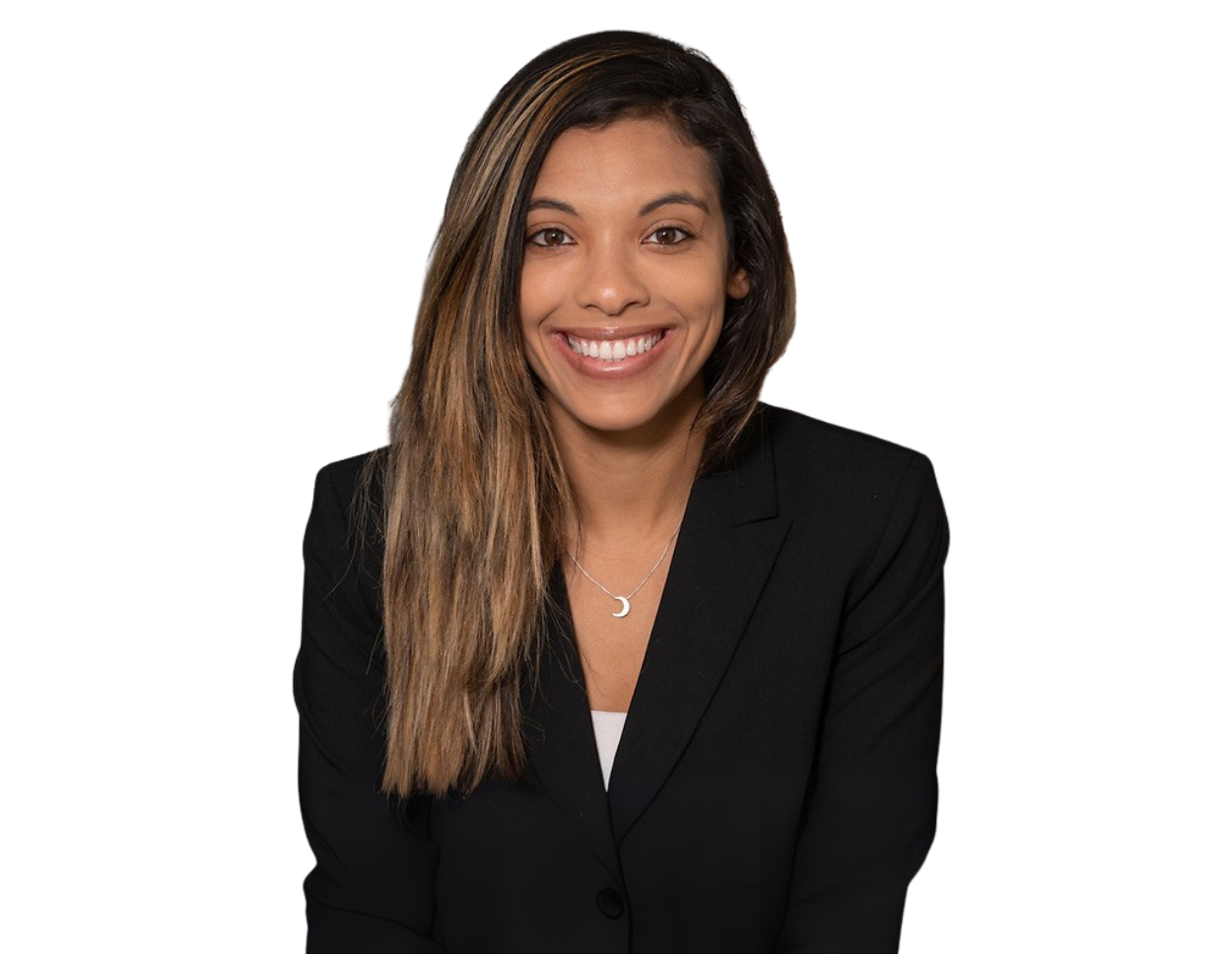 Professional headshot of Joyce Dos Santos wearing a black blazer and crescent moon necklace, posed against a transparent background. She appears confident and approachable, suggesting a professional or business context.