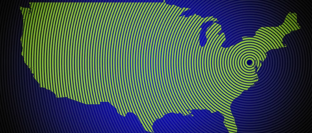 Green silhouette of the United States map centered on a dark blue background with subtle gradient shading. The simplified modern design emphasizes the recognizable outline of the country without state borders.