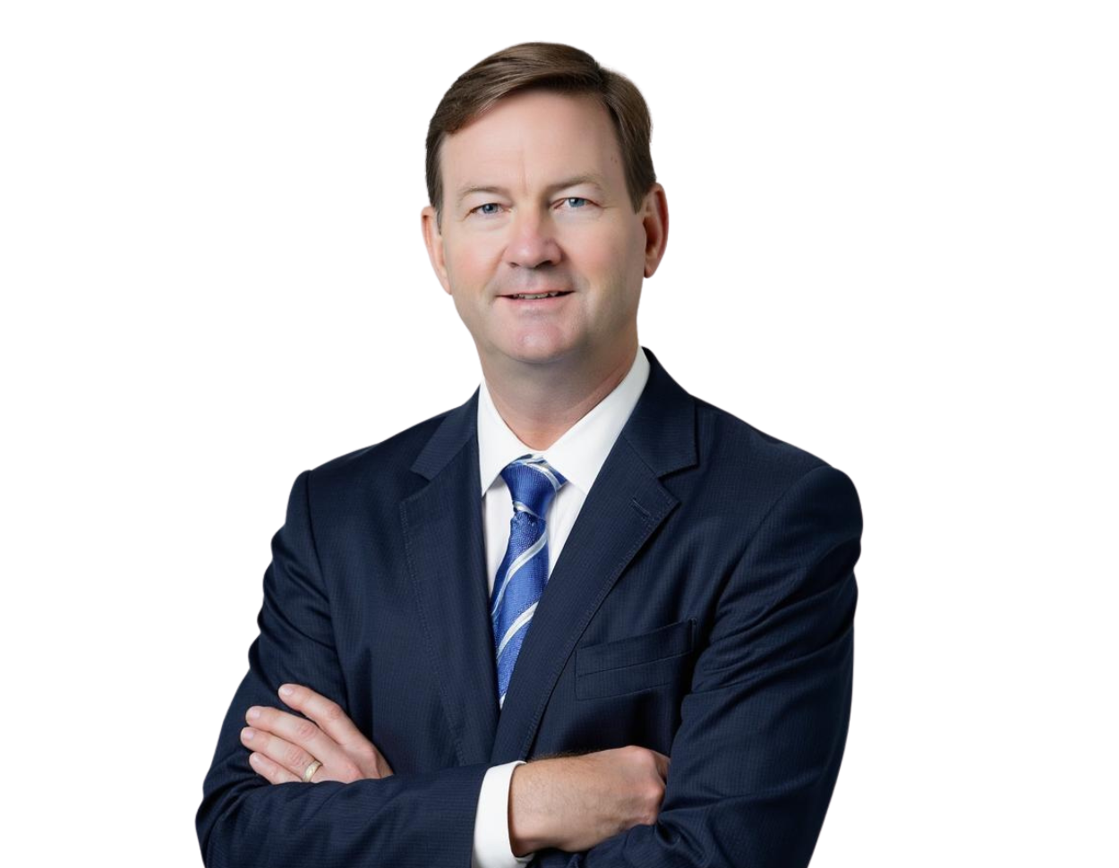 Hunter Johnson in a dark suit with a blue and white striped tie stands with arms crossed, smiling against a light blue and white geometric background.