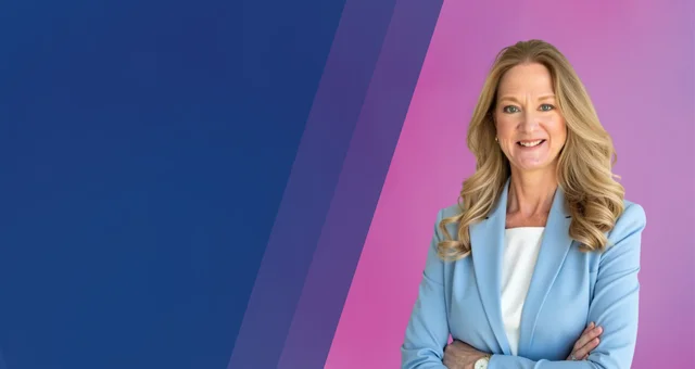 Smiling woman with long blonde hair wearing a light blue blazer stands with arms crossed against a blue and pink gradient background.