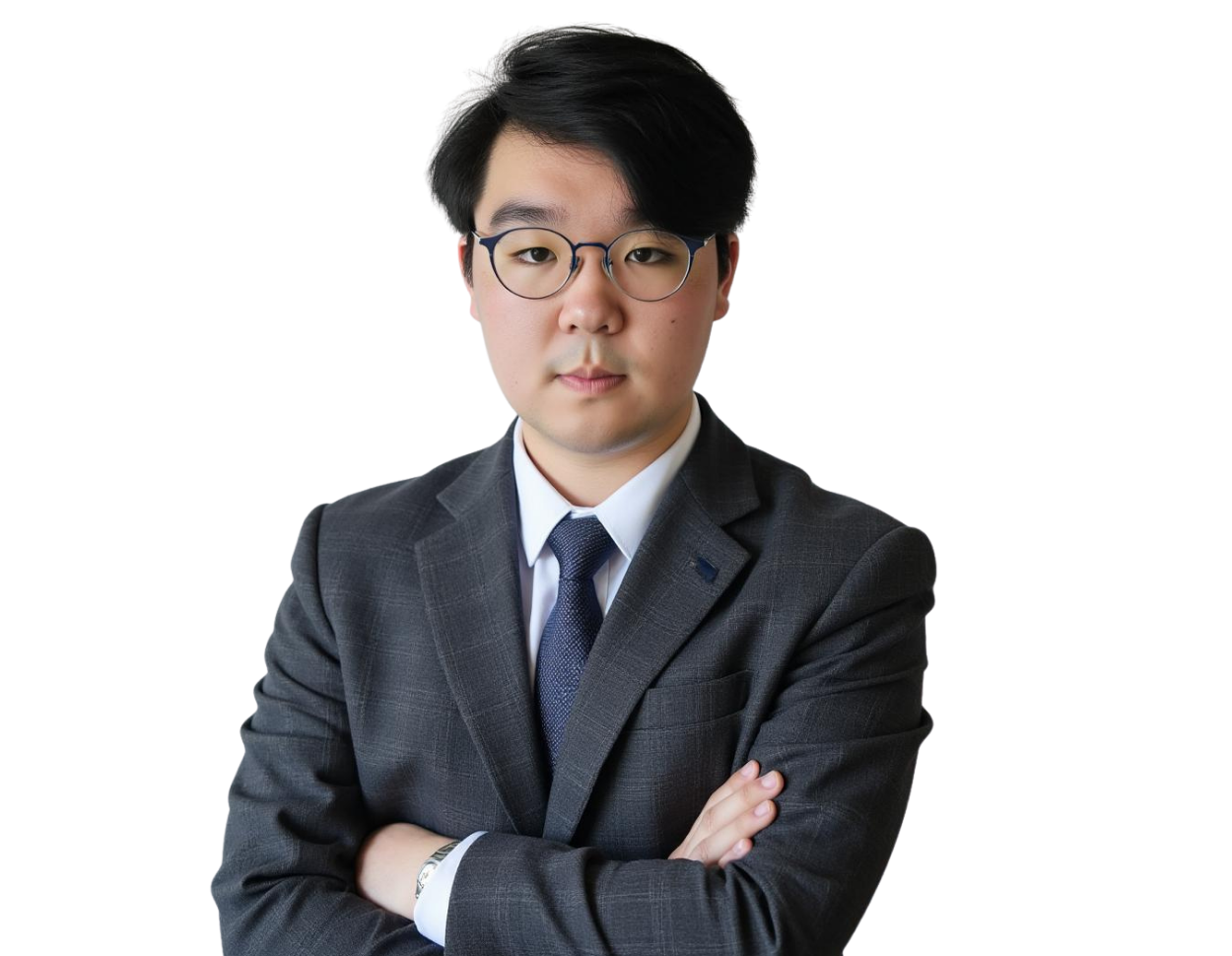 Professional man with short black hair and round glasses wearing a gray suit, white dress shirt, and dark blue tie, standing with arms crossed against a transparent background. He has a serious, focused expression that conveys professionalism and confiden