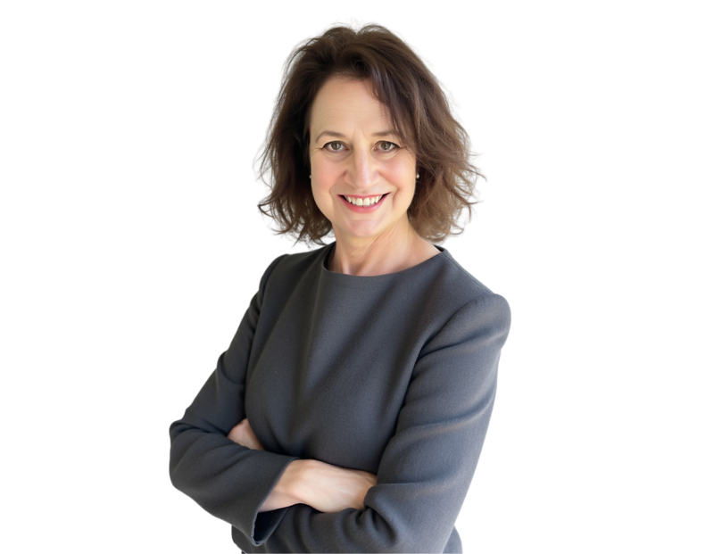 A professional portrait of a woman with shoulder-length brown hair styled in soft waves. She is smiling directly at the camera and wearing a long-sleeved dark gray dress. Her arms are crossed in a confident, approachable pose.