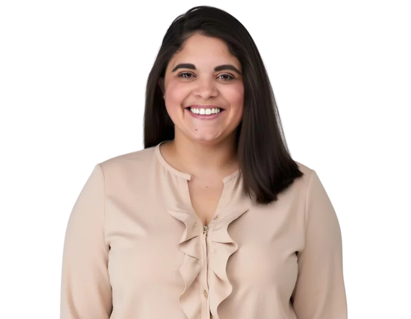 Professional headshot of Addia Rodriguez smiling, wearing a light-colored blouse, with long hair styled neatly, posed against a simple background.
