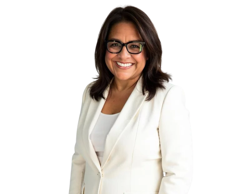 Lynda Jensen wearing a white blazer over a light top, posed against a light blue and white geometric background.