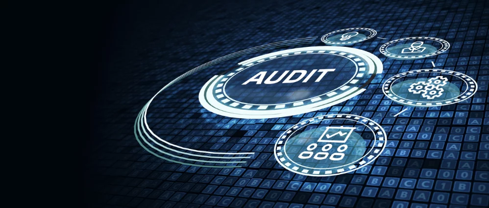Digital interface displaying the word AUDIT in a circular futuristic design over a dark blue data grid background. Surrounding icons show charts, gears, a user profile, and analytics symbols, connected in a network style layout.