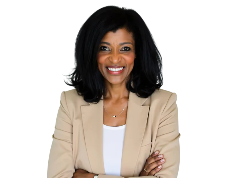 Confident woman smiling with arms crossed, wearing a beige blazer over a white top. She has shoulder-length black hair and a natural, professional look, standing against a transparent background.